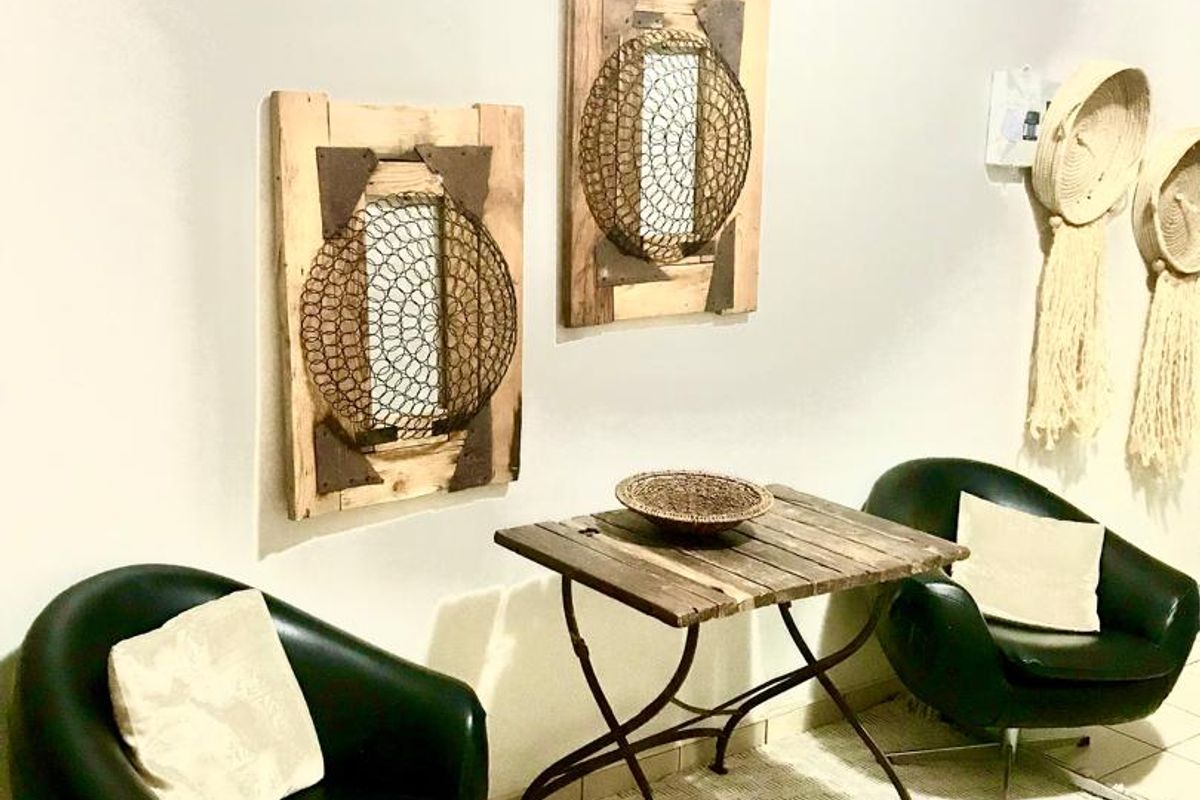 A well-maintained interior space featuring neutral wall finishes and tiled flooring, suitable for a waiting area or casual seating zone.