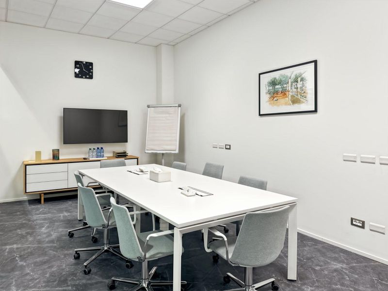 A modern, well-lit office meeting room featuring a clean, professional layout with integrated electrical and data connectivity.