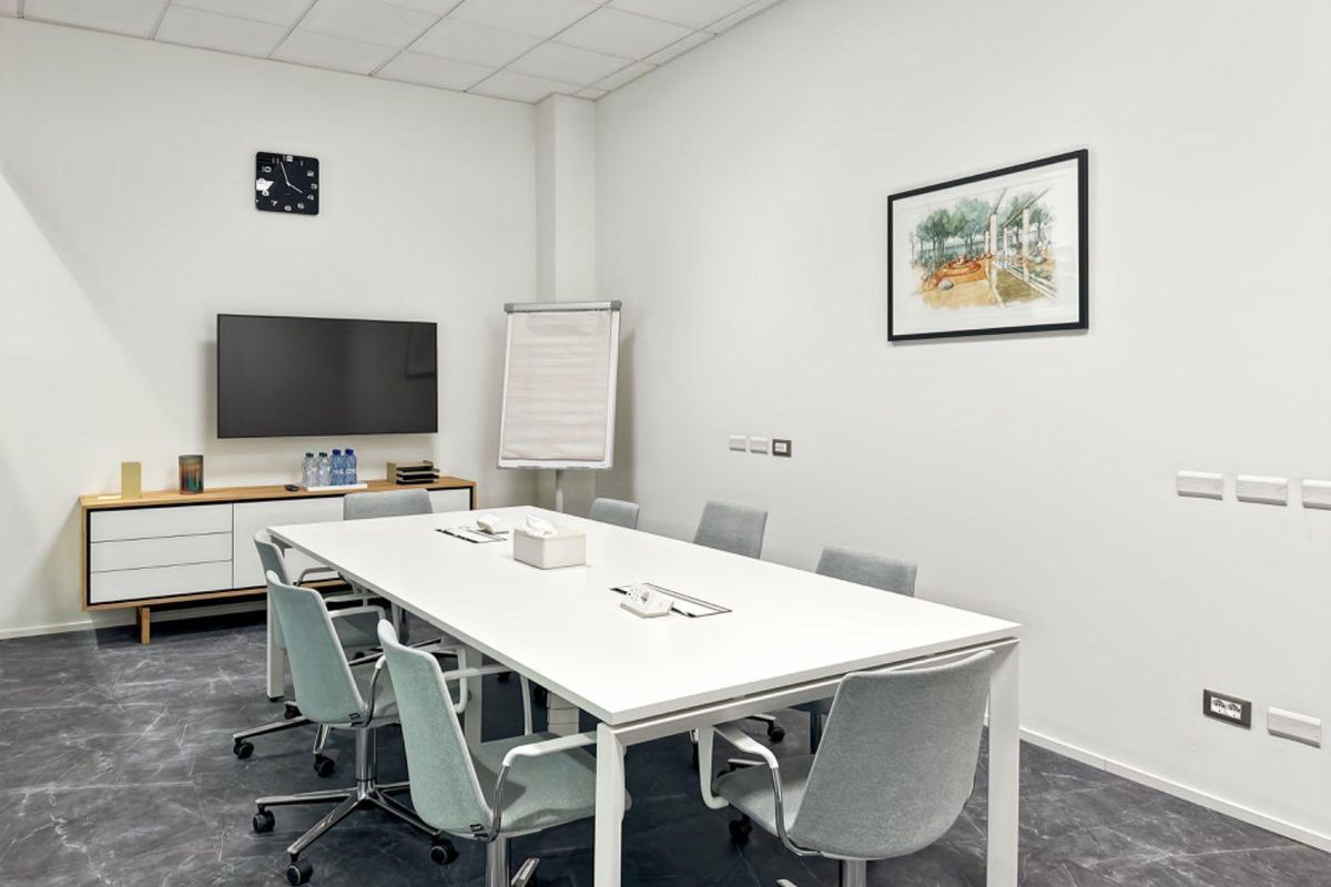 A modern, well-lit office meeting room featuring a clean, professional layout with integrated electrical and data connectivity.