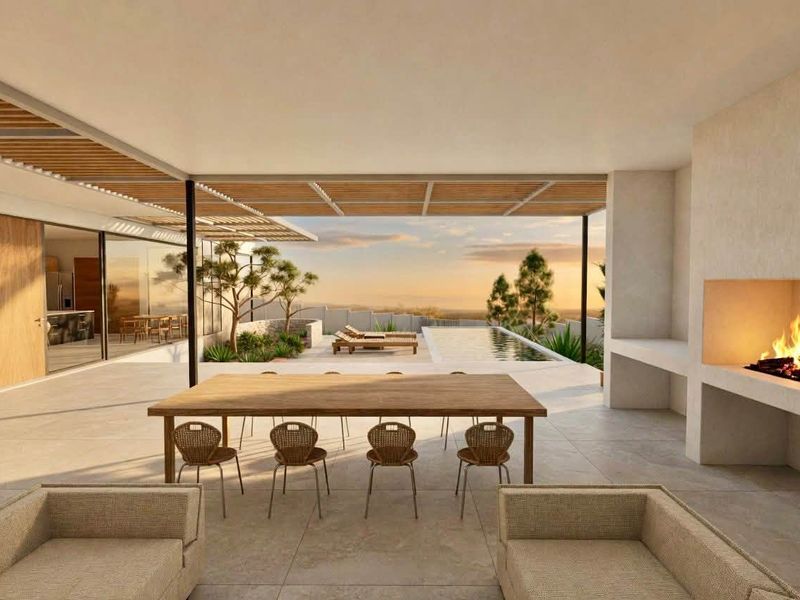 Spacious covered patio featuring a built-in fireplace, tiled flooring, and a slatted timber pergola, overlooking a private swimming pool and scenic landscape.