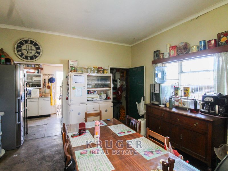 Open plan dining area featuring built-in cabinetry and direct access to a secondary scullery space.