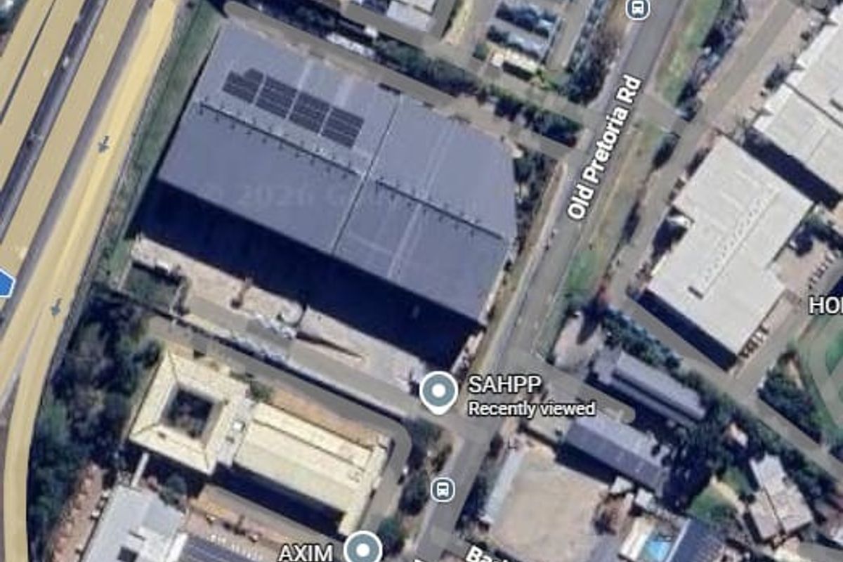 Aerial view of the industrial property site showing the main warehouse structure, surrounding road access, and neighbouring commercial facilities.