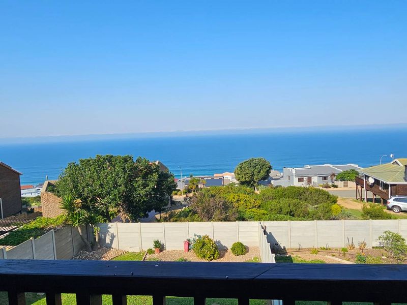 Elevated coastal view overlooking the neighborhood and ocean, captured from a balcony.