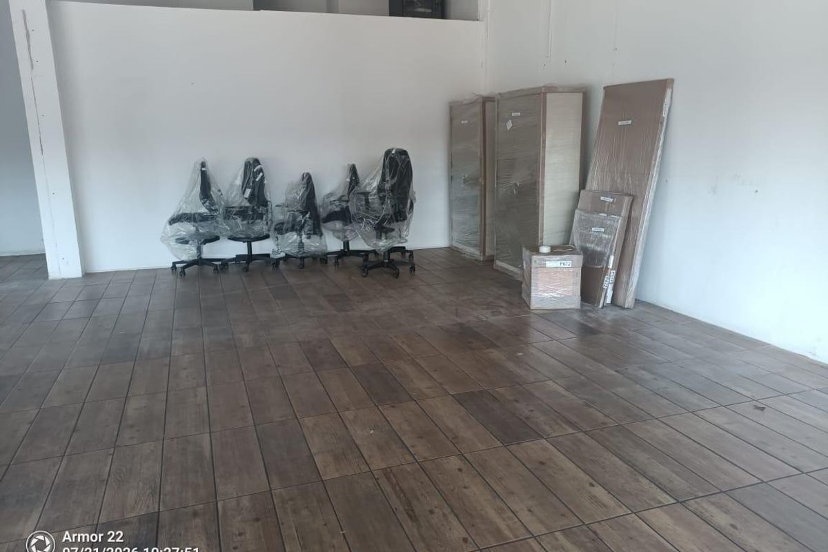 Open plan retail space featuring wood-look tile flooring and neutral white walls, suitable for a variety of commercial business applications.