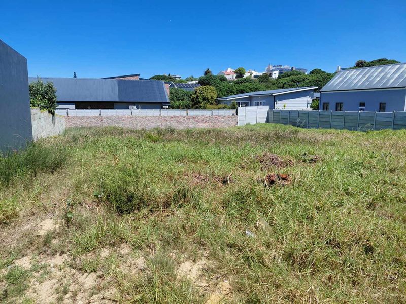 A vacant residential plot featuring established perimeter brick and precast concrete boundary walls, ready for development.