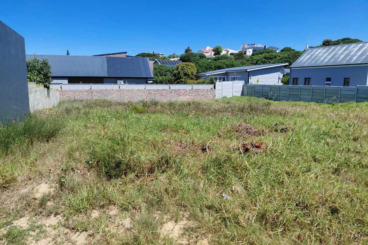 A vacant residential plot featuring established perimeter brick and precast concrete boundary walls, ready for development.