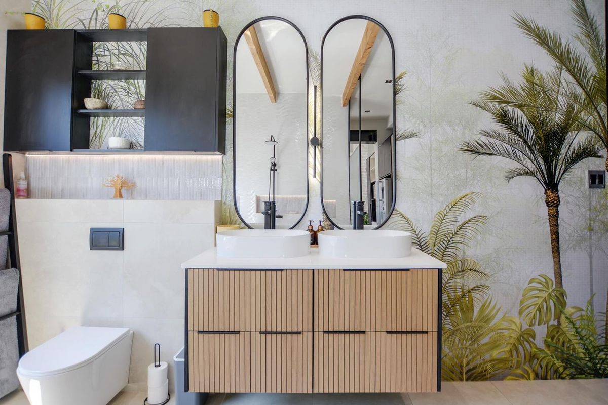 Modern bathroom featuring a double vanity with vessel sinks, black tapware, wall-mounted toilet, and decorative wall finishes with integrated lighting.