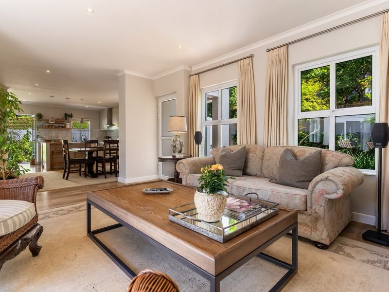 Spacious open-plan living and dining area featuring modern laminate flooring, recessed lighting, and a seamless flow into a well-appointed kitchen.