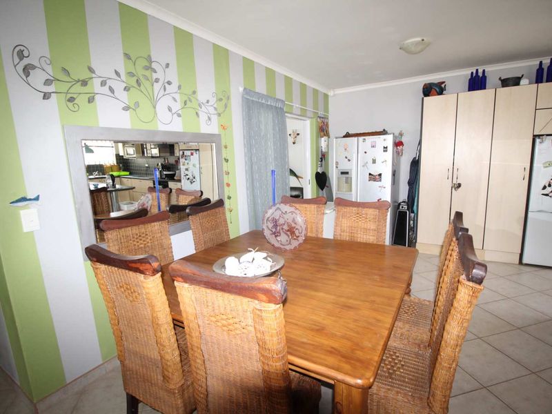 Dining area featuring tiled flooring and built-in cabinetry, providing a functional space for family meals.