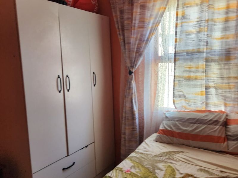 A bedroom featuring a built-in wardrobe and decorative coving, providing functional storage space within the room.
