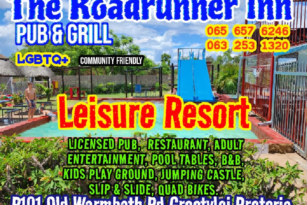 Outdoor pool area featuring a blue water slide and paved surrounds, situated within a leisure resort setting.