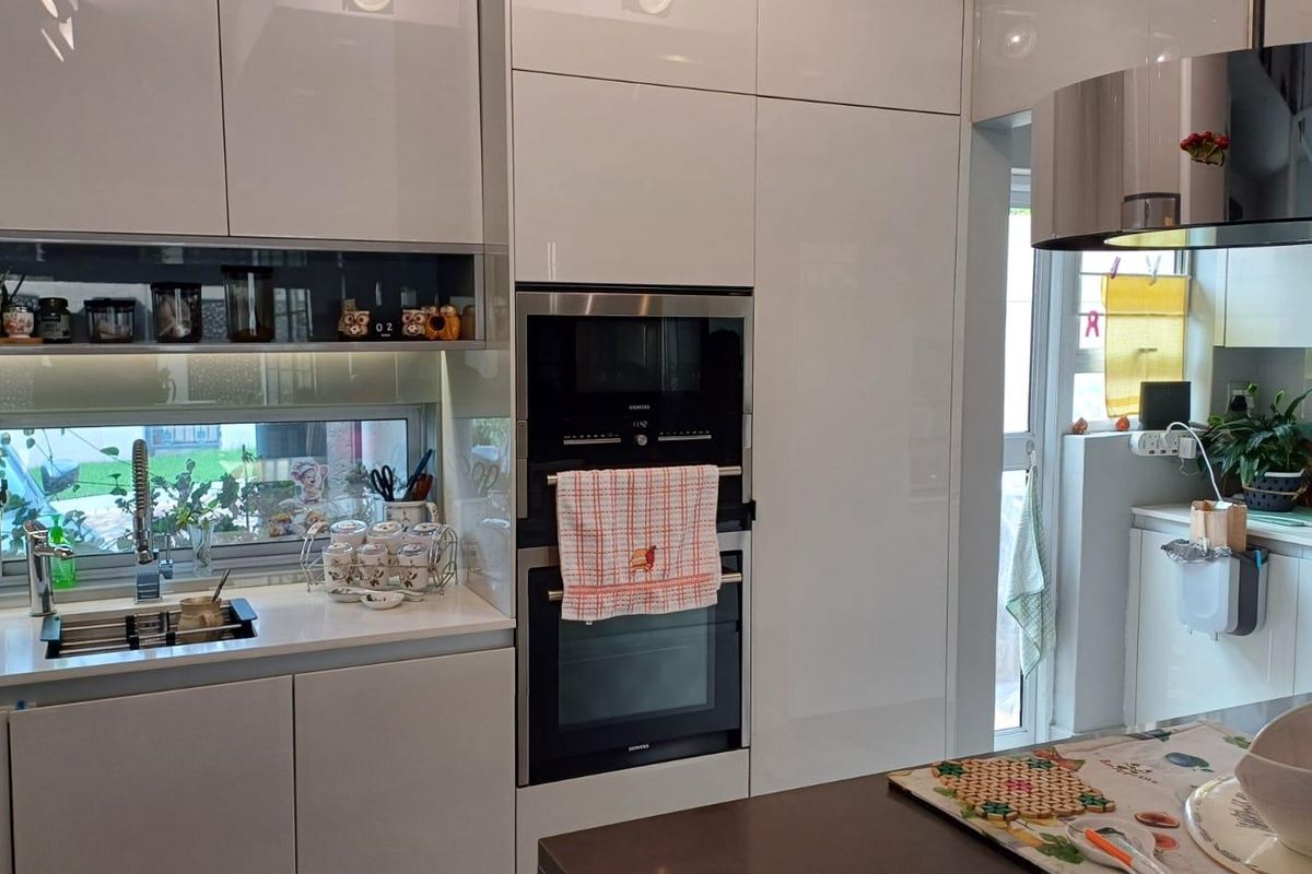 Modern kitchen featuring high-gloss white cabinetry, integrated appliances including an oven and microwave, quartz countertops, and a sleek undermount sink.