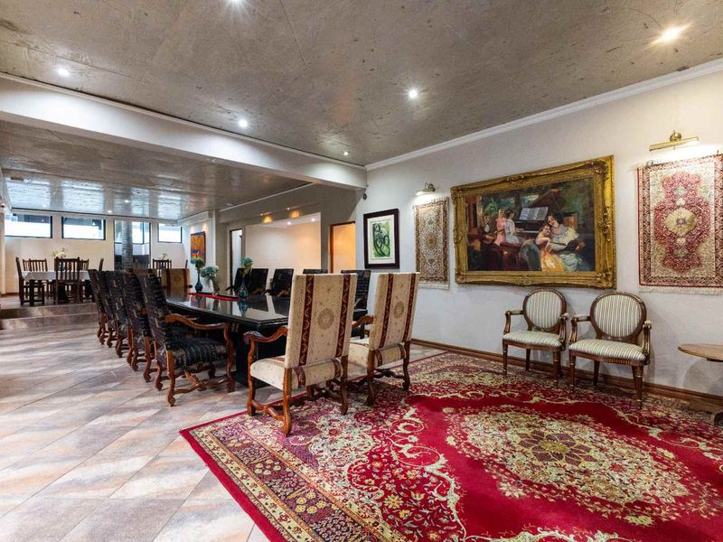 Spacious dining room featuring tiled flooring, recessed downlighting, and a coved ceiling, providing an elegant setting for formal gatherings.