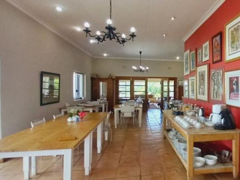 Spacious open-plan living and dining area featuring tiled flooring, recessed lighting, and large sliding glass doors leading to the exterior.