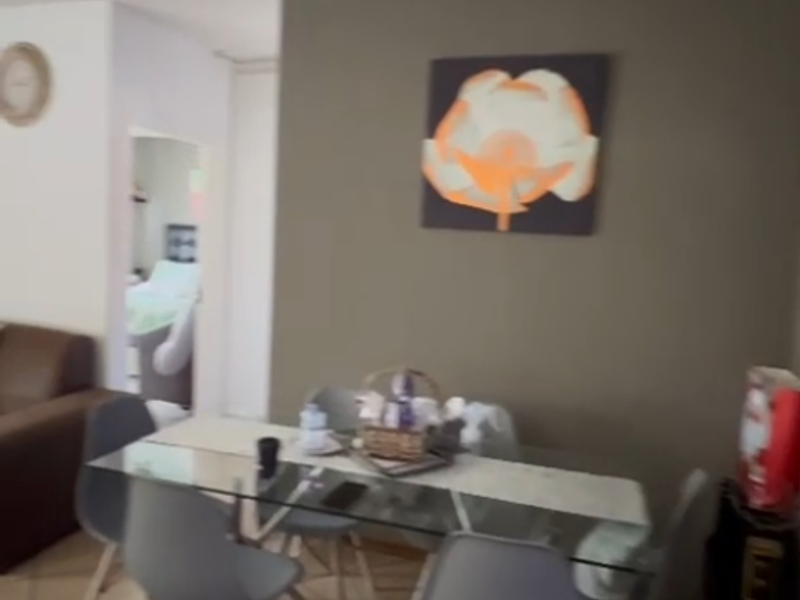 A dining area featuring tiled flooring and an open-plan layout connecting to adjacent living spaces.