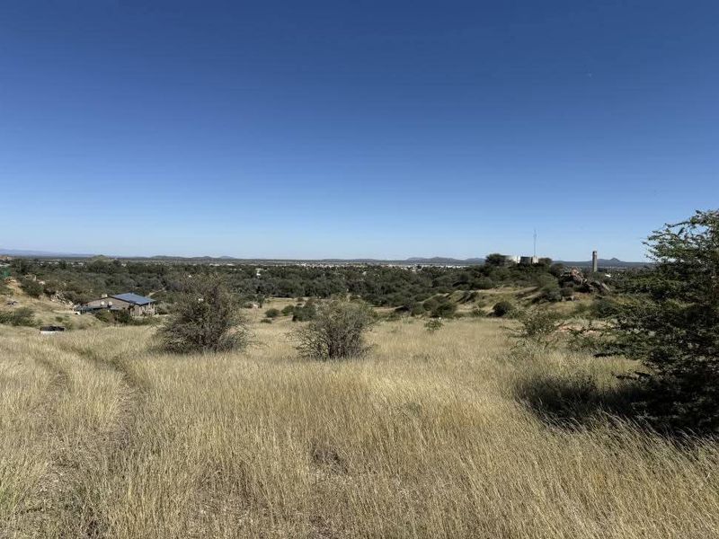 A wide-angle view of the vacant residential land, showcasing the natural landscape, native vegetation, and surrounding area.