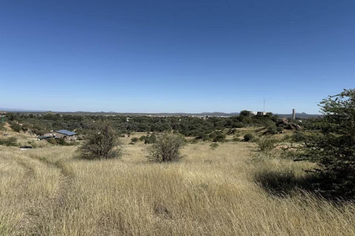 A wide-angle view of the vacant residential land, showcasing the natural landscape, native vegetation, and surrounding area.