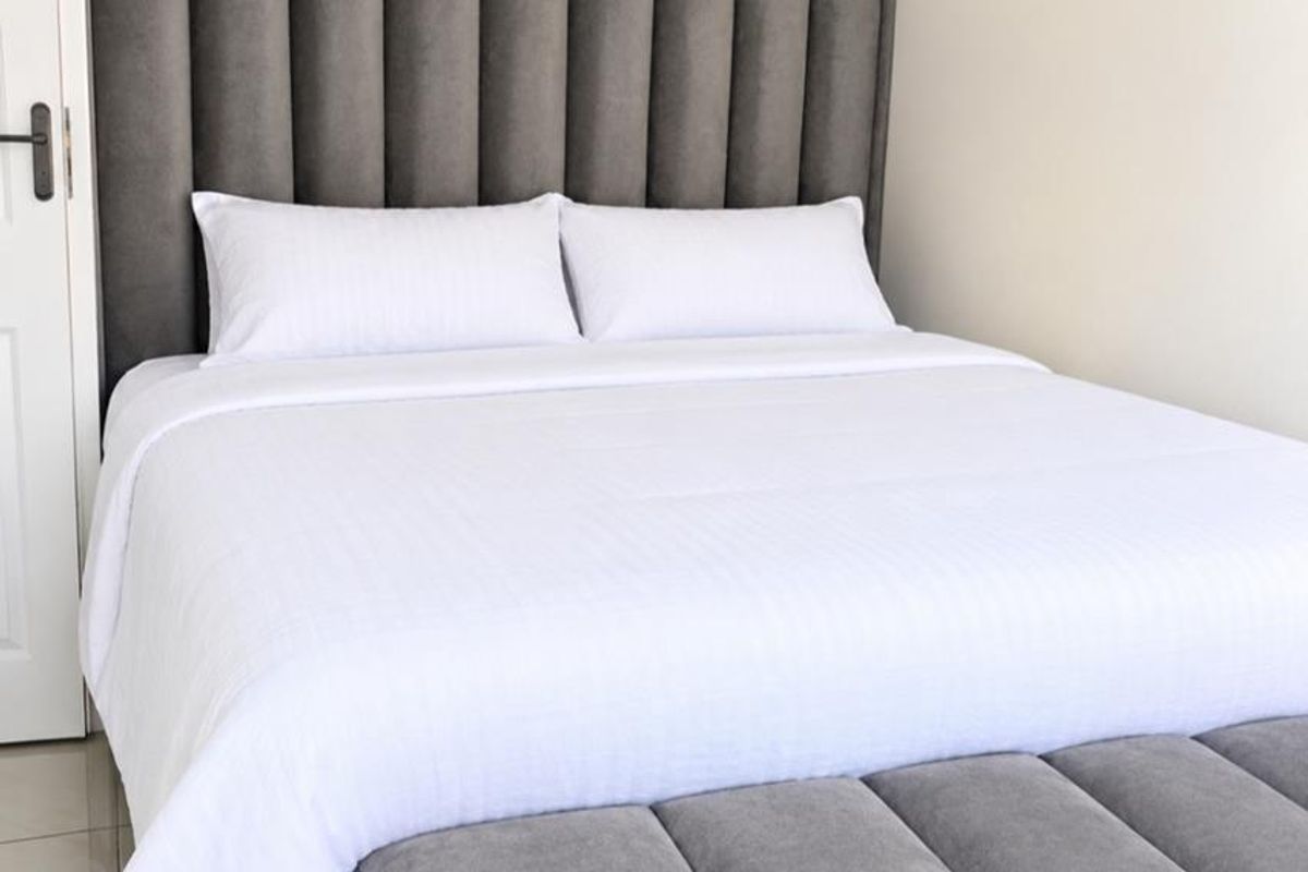 A well-maintained bedroom featuring neutral wall finishes and tiled flooring, providing a clean and comfortable living space.