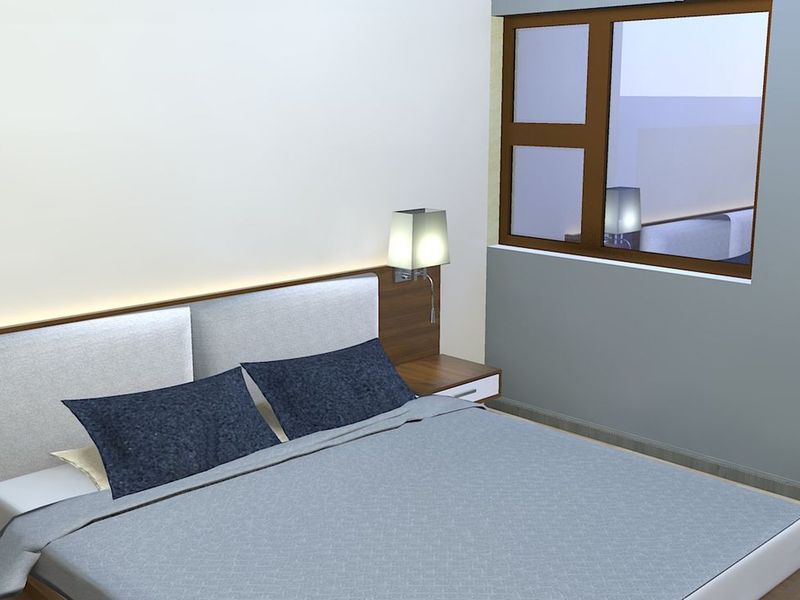 A modern bedroom featuring a built-in headboard with integrated bedside tables and lighting, finished with clean lines and neutral tones.