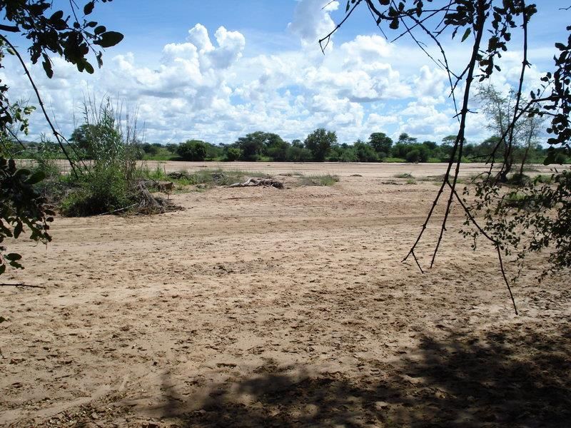 A scenic view of the natural landscape and dry riverbed on the small holding property.