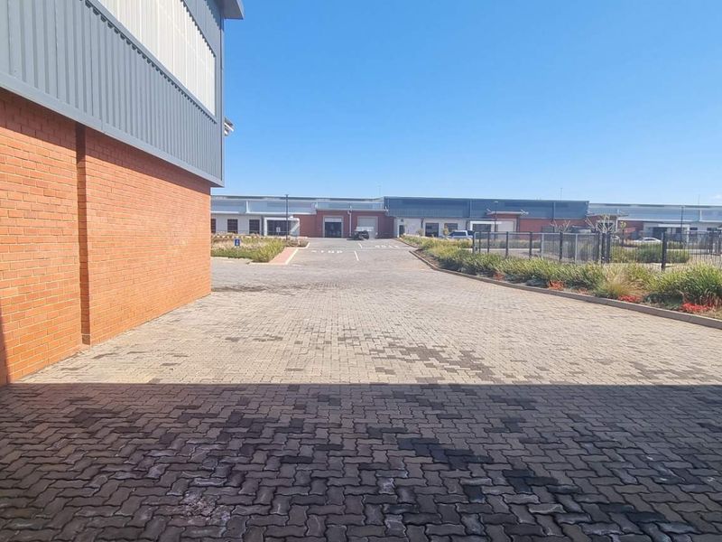 A view of the paved industrial driveway and exterior brick and metal facade of the warehouse facility.