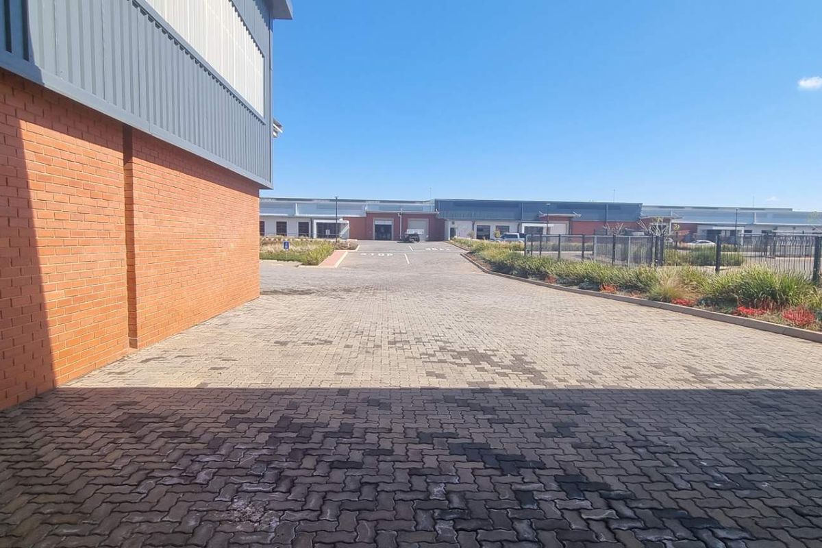 A view of the paved industrial driveway and exterior brick and metal facade of the warehouse facility.