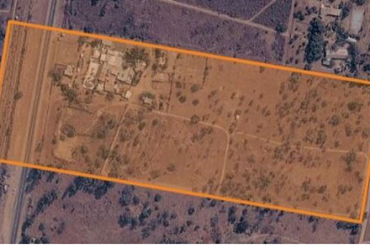 Aerial view of the small holding property showing the land boundaries, existing structures, and surrounding landscape.