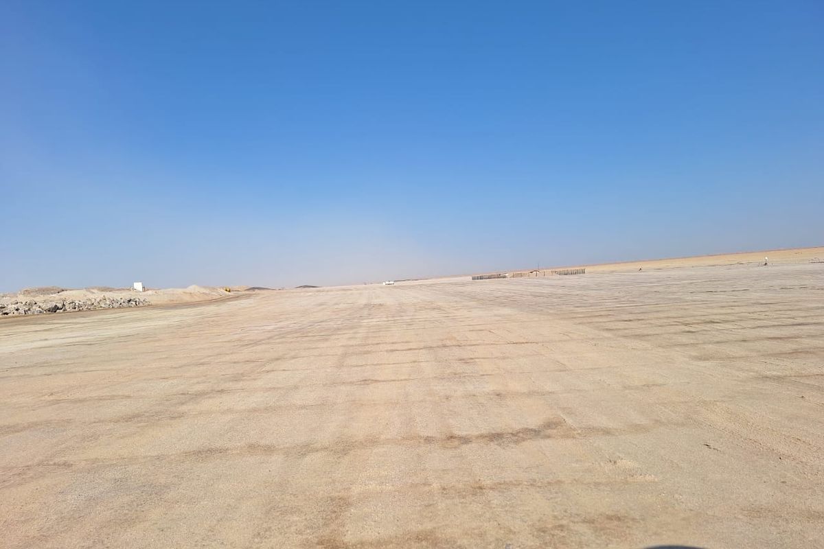 A wide, open, and cleared industrial land plot with a flat, graded surface, suitable for development or storage purposes.