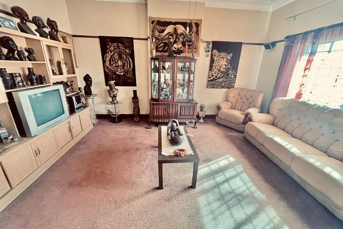 A traditional living room featuring built-in cabinetry, ornate ceiling cornicing, and a picture rail, offering a classic foundation for modern updates.