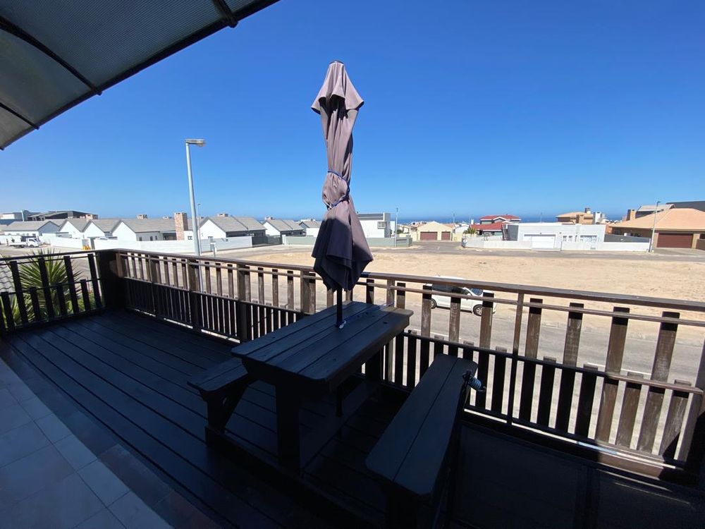First-floor balcony with distant sea view