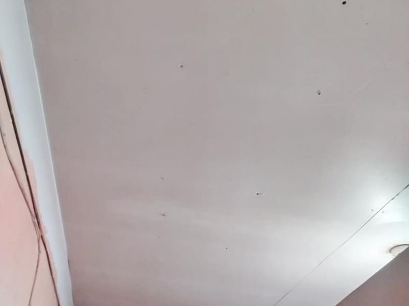 A close-up view of a ceiling showing visible cracks and surface damage requiring repair.