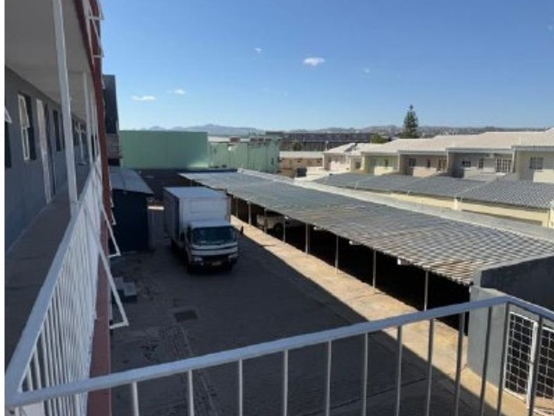 View from an apartment balcony overlooking the complex parking area and surrounding neighborhood.