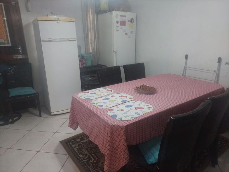 A dining area featuring tiled flooring, providing a functional space for meals.