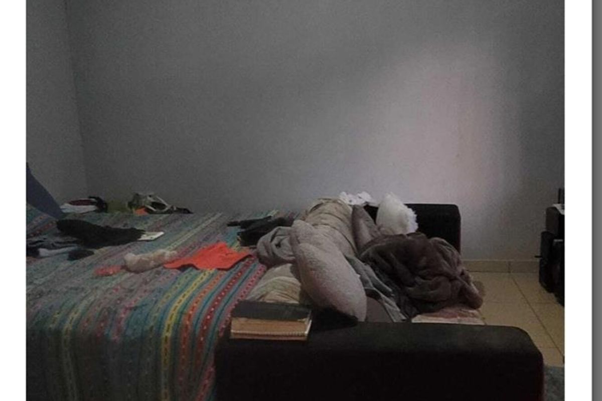 A bedroom featuring tiled flooring and coving, providing a functional space for rest.