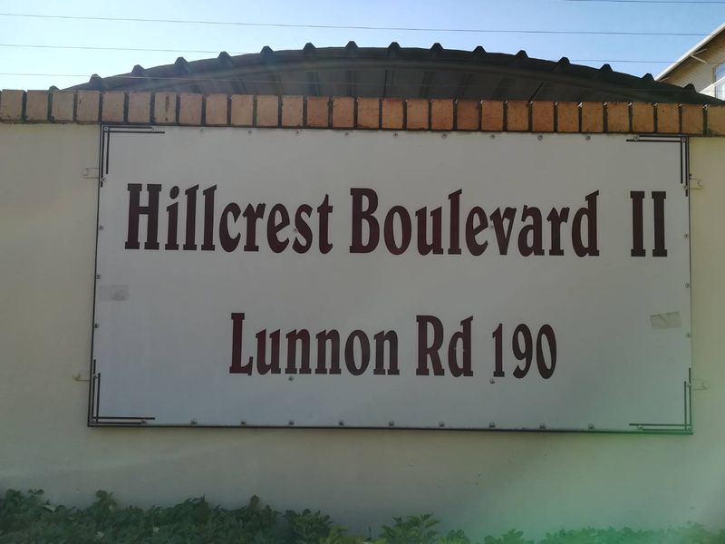 Exterior signage for Hillcrest Boulevard II located on Lunnon Road, mounted on a brick-capped boundary wall.