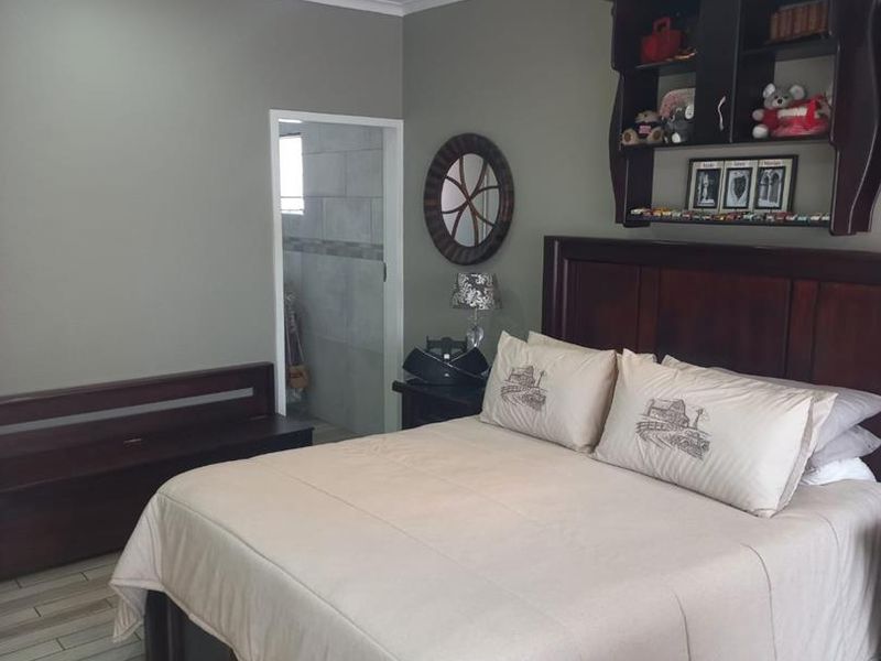 A bedroom featuring tiled flooring, recessed downlighting, a ceiling fan, and direct access to an en-suite bathroom.