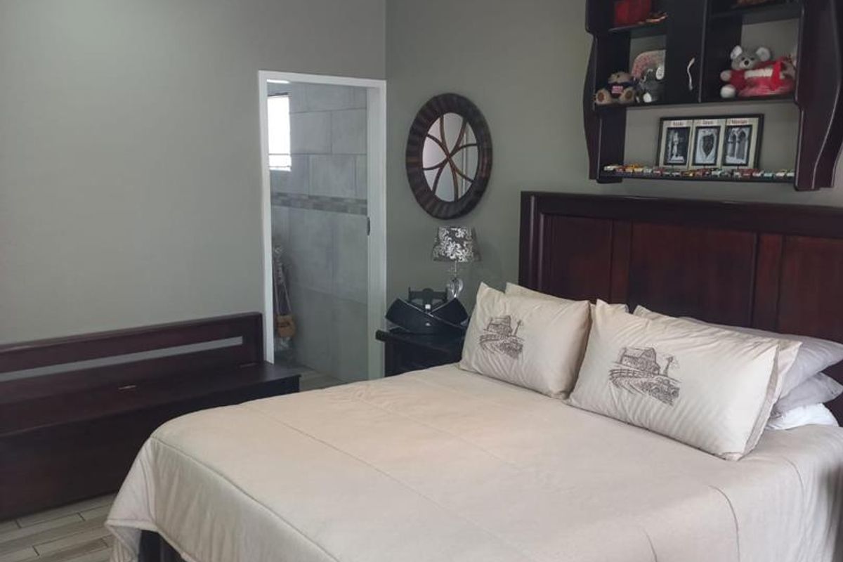 A bedroom featuring tiled flooring, recessed downlighting, a ceiling fan, and direct access to an en-suite bathroom.