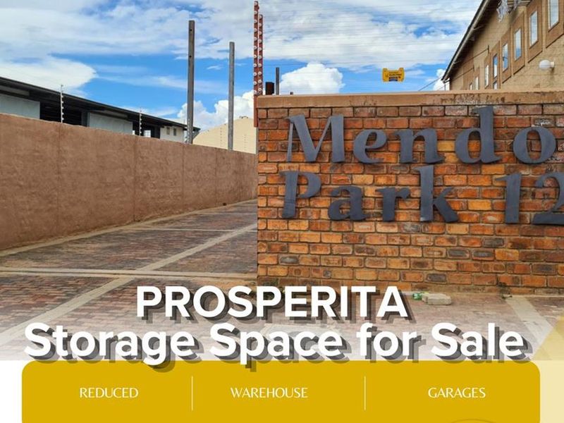 Exterior view of Mendo Park in Prosperita, featuring brick boundary walls, paved driveway, and industrial storage units.