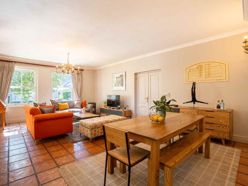 Spacious open-plan living and dining area featuring traditional terracotta floor tiles, coving, and large sash windows providing ample natural light.