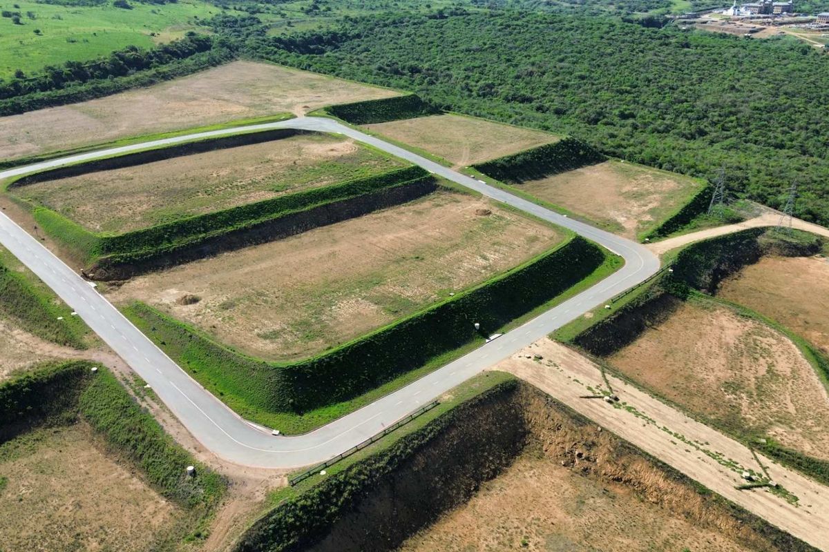 Aerial view of a developed industrial land parcel featuring terraced plots and established paved access roads within a landscaped setting.