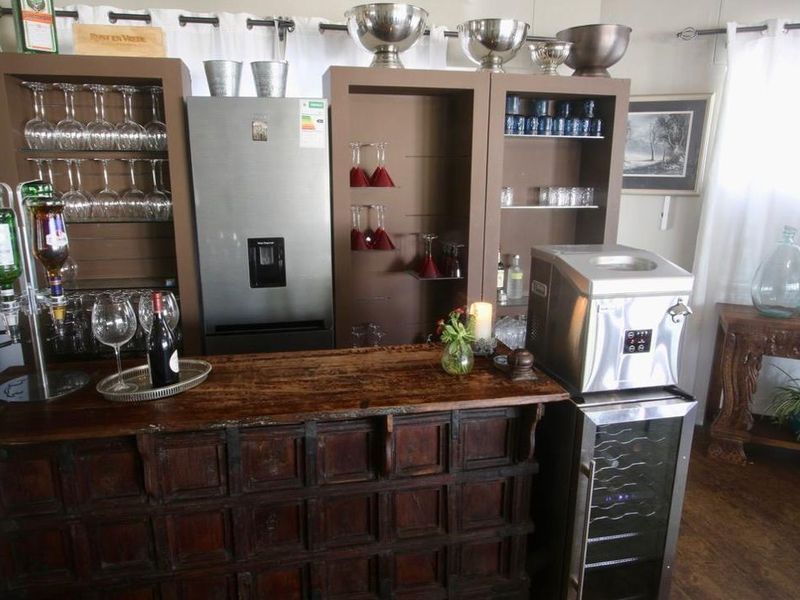 A dedicated home bar area featuring custom built-in shelving units and dark wood cabinetry, providing a functional space for entertaining.