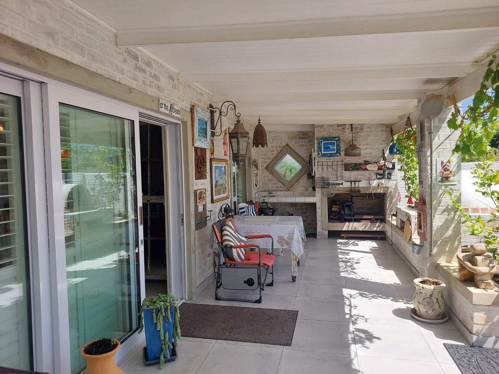 Built in braai, seating area and entrance door.