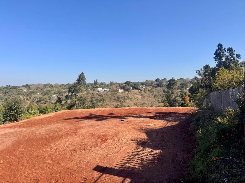 A vacant residential plot featuring elevated landscape views and natural terrain, ready for development.