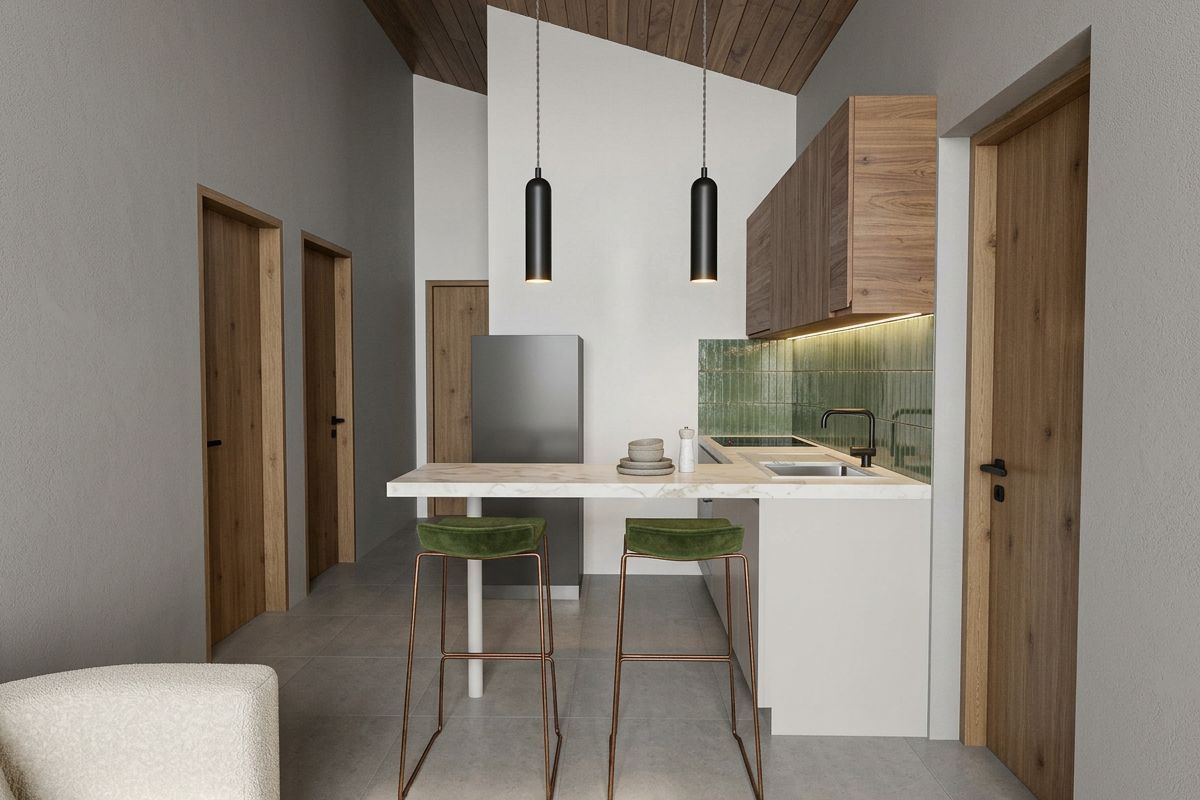 Modern open-plan kitchen featuring sleek cabinetry, a stone breakfast bar, integrated sink, and stylish green subway tile backsplash under a vaulted timber ceiling.