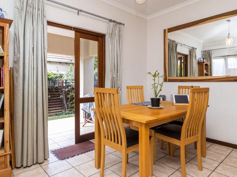 Dining area featuring tiled flooring and a sliding glass door providing direct access to the outdoor patio area.