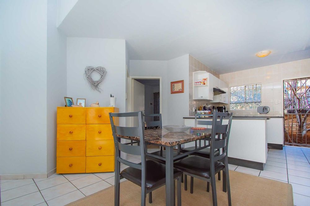 Dining room with kitchen in background