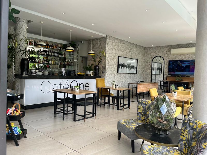 A well-maintained commercial bar area featuring a built-in service counter, recessed lighting, and modern tiled flooring, suitable for hospitality use.