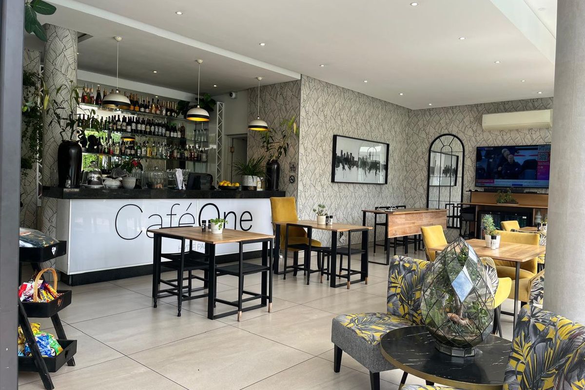 A well-maintained commercial bar area featuring a built-in service counter, recessed lighting, and modern tiled flooring, suitable for hospitality use.