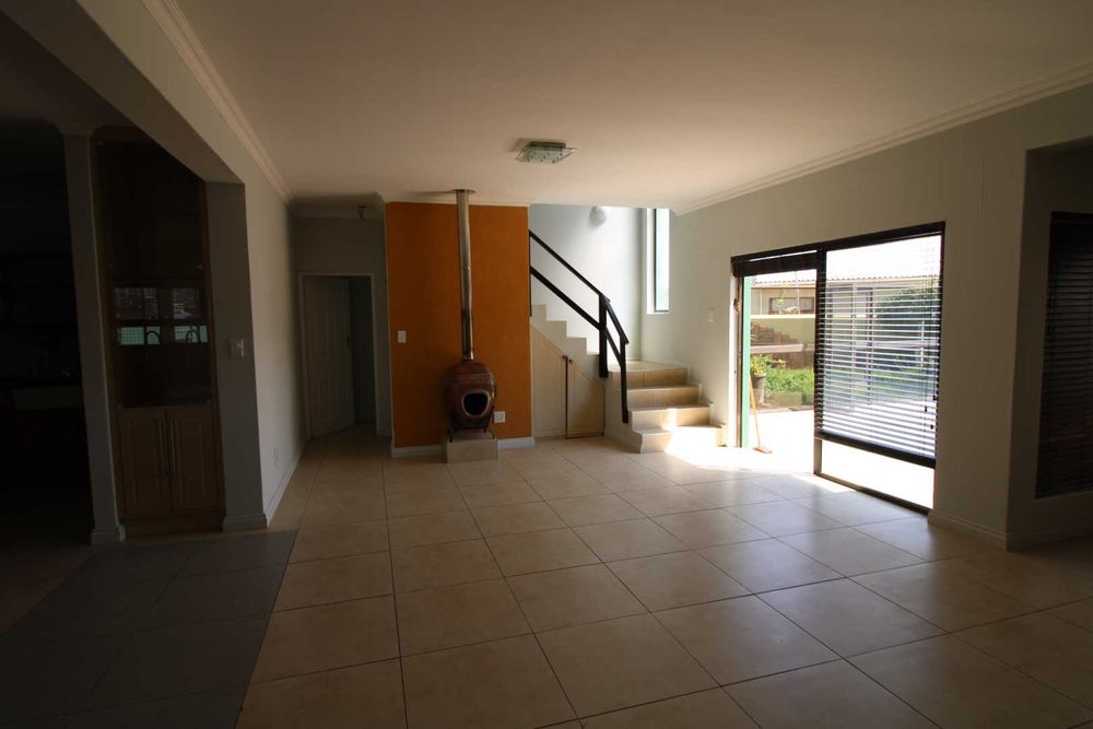 Lounge with fire place leading out into garden