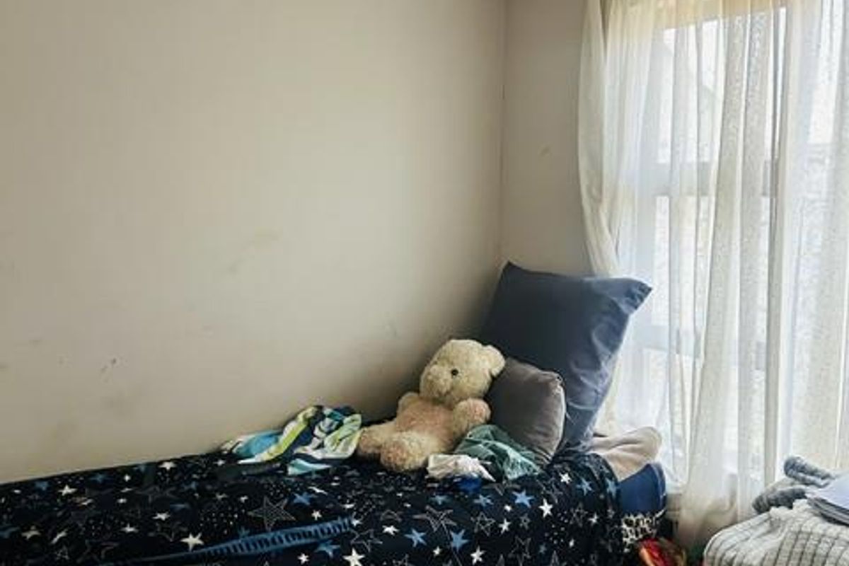 A bedroom featuring tiled flooring, recessed ceiling lighting, and a large window with curtain rod.